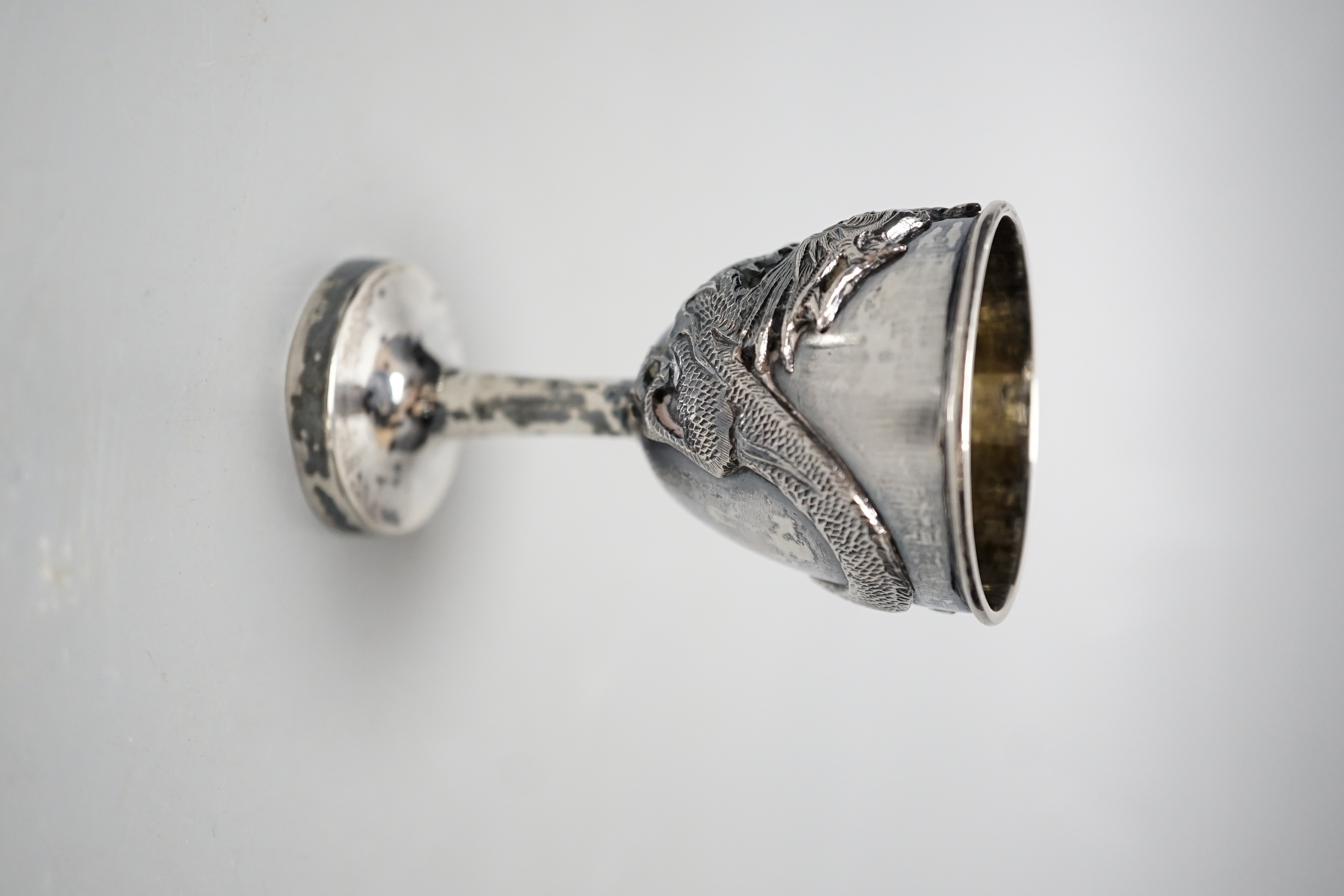 An early 20th century Chinese Export white metal dragon ‘egg’ cup and spoon, by Zee Shun, cup 76mm.